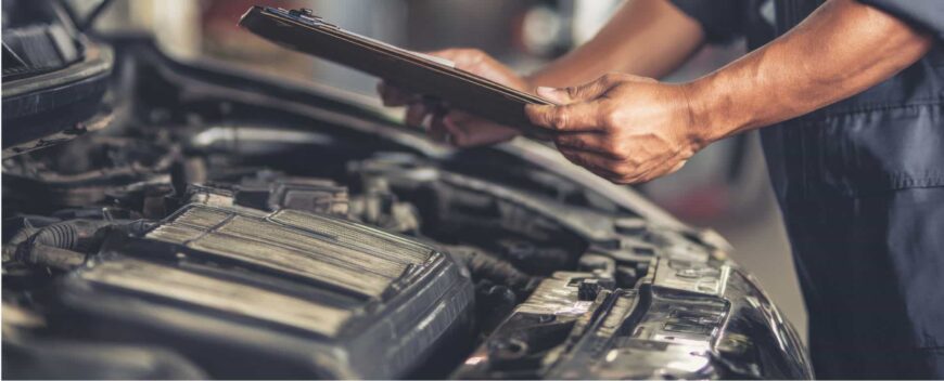 Vehicle undergoing NYS safety and emissions inspection with advanced diagnostic equipment
